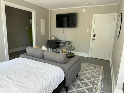 a bedroom with a bed and a couch and a tv at Lennox C301 Peaceful & Perfect Studio Apt in Philadelphia