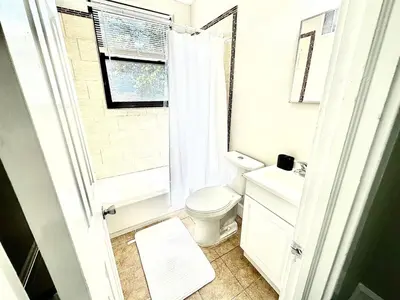 a bathroom with a toilet and a sink and a window at Lennox C301 Peaceful & Perfect Studio Apt in Philadelphia