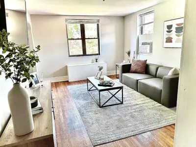 a living room with a couch and a table at Lennox C407 Cozy and Spacious Studio1br Apt in Philadelphia