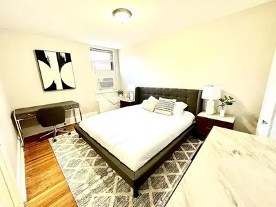a bedroom with a bed and a chair in it at Lennox C304 Peaceful & Perfect Private 1-br in Philadelphia
