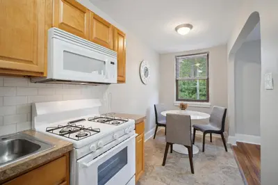 a kitchen with a stove and a sink and a table at Lennox C302 Peaceful & Perfect Private 1Br in Philadelphia
