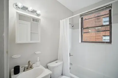 a white bathroom with a toilet and a sink at Lennox C302 Peaceful & Perfect Private 1Br in Philadelphia