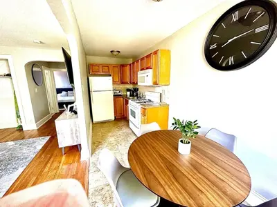 a kitchen with a table and a clock on the wall at Lennox C409 Peaceful & Perfect Private 1-Br in Philadelphia
