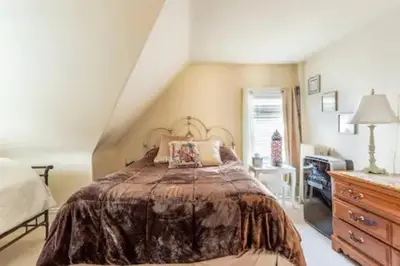 a bedroom with a bed and a dresser at Large Space Great for Groups & Families in Montclair