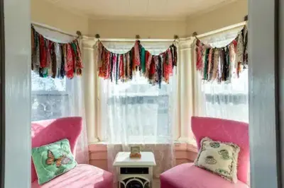 a room with two pink chairs and a window at Large Space Great for Groups & Families in Montclair