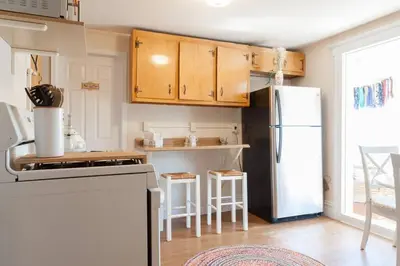a kitchen with a refrigerator and a table and chairs at Large Space Great for Groups & Families in Montclair