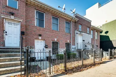 a brick building with a gate in front of it at 3br private Apartment in Jersey City