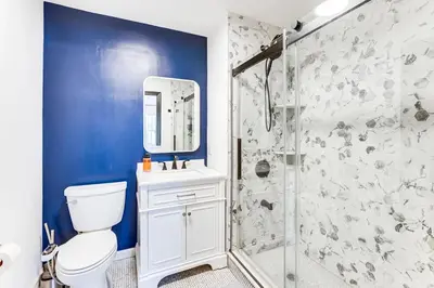 a bathroom with a white toilet and a shower at 3br private Apartment in Jersey City