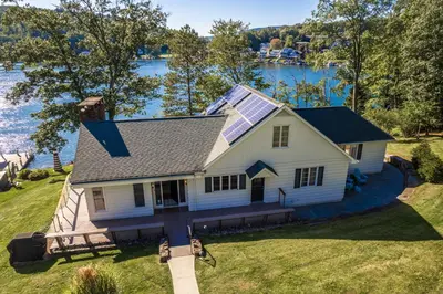 an aerial view of a house with a lake in the background at Lakefront Home at Lake Winola, PA in Factoryville