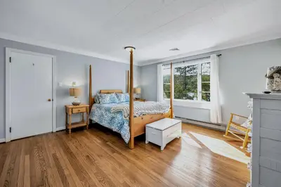 a bedroom with a canopy bed and a wooden floor at Lakefront Home at Lake Winola, PA in Factoryville