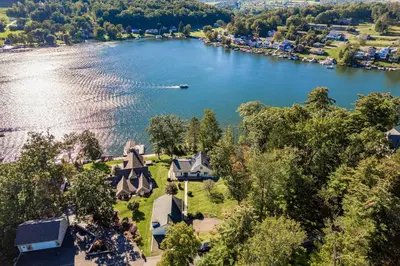 an aerial view of a house on the shore of a lake at Lakefront Home at Lake Winola, PA in Factoryville