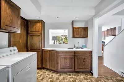 a kitchen with wooden cabinets and a sink at Lakefront Home at Lake Winola, PA in Factoryville