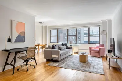 a living room with a couch and a table at Kips Bay 1br w gym nr empire state building NYC-1214 in New York