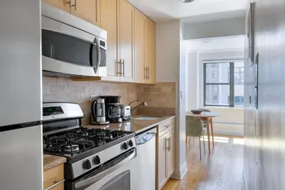 a kitchen with a stove and a microwave at Kips Bay 1br w gym nr empire state building NYC-1214 in New York