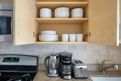 a kitchen counter with a stove and some dishes at Kips Bay 1br w gym nr empire state building NYC-1214 in New York