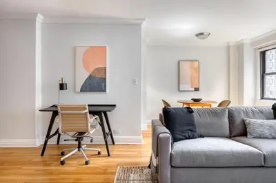 a living room with a couch and a desk at Kips Bay 1br w gym nr empire state building NYC-1214 in New York