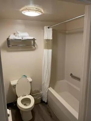 a bathroom with a toilet and a bath tub at Express Inn-Rahway in Rahway