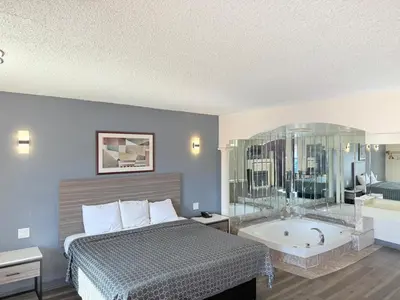 a hotel room with a bed and a bath tub at Express Inn-Rahway in Rahway