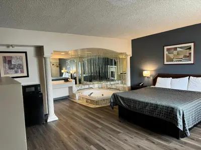 a hotel room with a bed and a bath tub at Express Inn-Rahway in Rahway