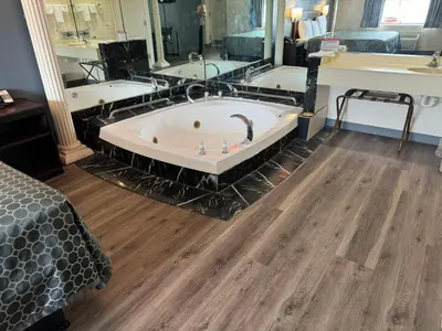 a large bathroom with a tub and a large mirror at Express Inn-Rahway in Rahway