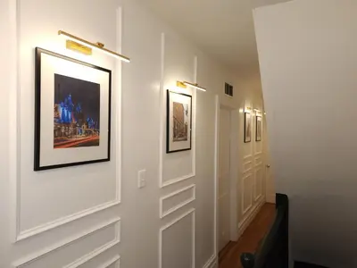 a hallway with framed pictures on the walls at Bethlehem Bliss:10min to Valley Festivals & Events in Bethlehem