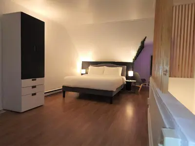 a bedroom with a bed and a dresser and a television at Bethlehem Bliss:10min to Valley Festivals & Events in Bethlehem