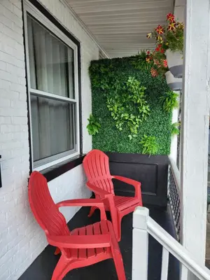 two red chairs sitting on a porch next to a window at Bethlehem Bliss:10min to Valley Festivals & Events in Bethlehem