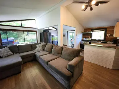 a living room with a couch and a kitchen at little cozy house in a village in Mountain Dale