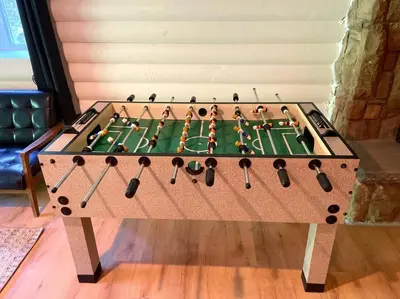a wooden foosball table with a green table at The Stone Mason - Large Modern Home on 5 Acres - 2 Hrs from NYC in Pond Eddy
