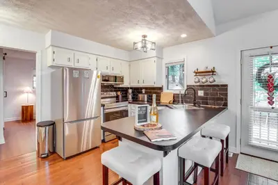 a kitchen with a refrigerator and a table with chairs at Deck, Fire Pit and Pool Access Pennsylvania Home! in Albrightsville