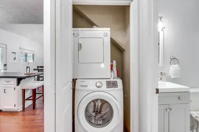a laundry room with a washer and dryer in a kitchen at Deck, Fire Pit and Pool Access Pennsylvania Home! in Albrightsville