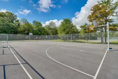 a tennis court with a basketball hoop at Deck, Fire Pit and Pool Access Pennsylvania Home! in Albrightsville