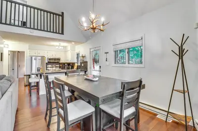 a kitchen and dining room with a table and chairs at Deck, Fire Pit and Pool Access Pennsylvania Home! in Albrightsville