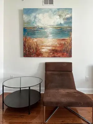 a chair and a table in a room with a painting at Peaceful Zen Getaway in the City in Philadelphia