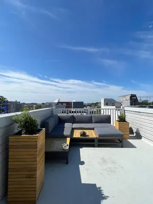 a patio with a couch and a table on a roof at Peaceful Zen Getaway in the City in Philadelphia