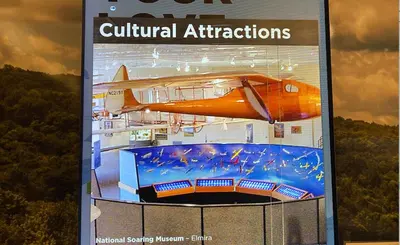 a magazine with a model of an airplane on it at Americas Best Value Inn Horseheads in Elmira