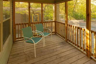 two chairs on the porch of a cabin at Sun Retreats Lancaster County in Narvon
