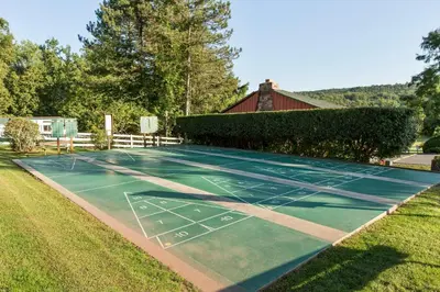 a tennis court in the yard of a house at Sun Retreats Lancaster County in Narvon