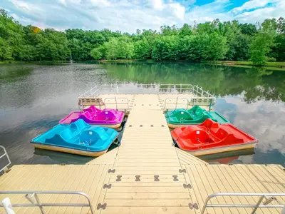 three boats sitting on a dock on a lake at Sun Retreats Lancaster County in Narvon