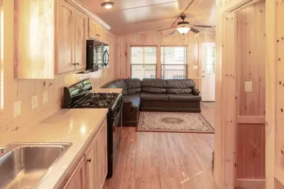 a kitchen and living room with a stove and a couch at Sun Retreats Lancaster County in Narvon