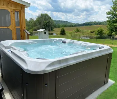 a large hot tub sitting on a deck at French Woods Farmhouse Bed & Breakfast in Hancock