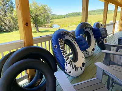 two rows of tires on a porch with a bench at French Woods Farmhouse Bed & Breakfast in Hancock