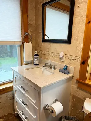 a bathroom with a sink and a mirror at French Woods Farmhouse Bed & Breakfast in Hancock