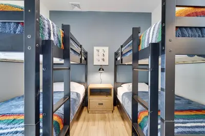 a bedroom with bunk beds in a dorm room at The Oasis at Arrowhead in Arrowhead Lake