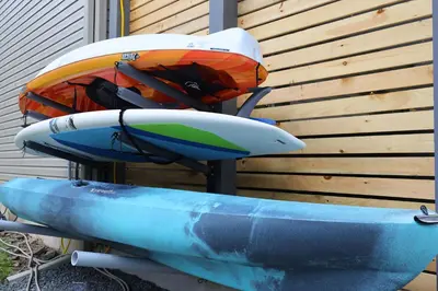 a group of kayaks sitting on top of a rack at The Oasis at Arrowhead in Arrowhead Lake