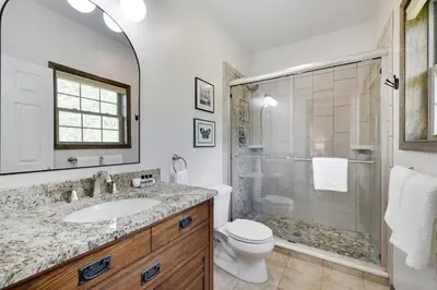 a bathroom with a sink and a toilet and a shower at The Oasis at Arrowhead in Arrowhead Lake