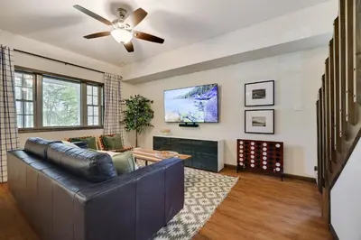 a living room with a couch and a flat screen tv at The Oasis at Arrowhead in Arrowhead Lake