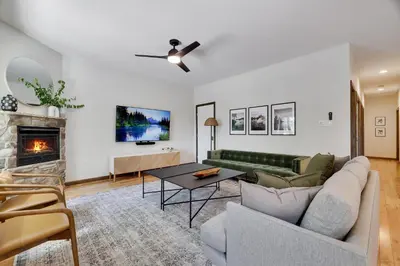 a living room with a couch and a fireplace at The Oasis at Arrowhead in Arrowhead Lake