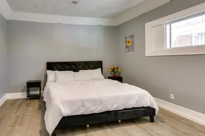 a bedroom with a large bed with a window at Chic Newark Vacation Rental 3 Mi to Airport! in Newark