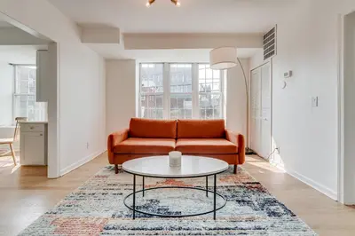 a living room with a couch and a table at Jersey City Monthly Boutique 20 Min to NYC in Jersey City